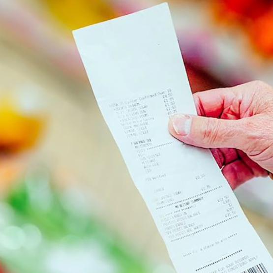 Client d'une grande surface consultant son ticket de caisse. © DR iStock