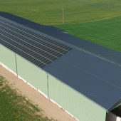 Le bâtiment de séchage en grange du GAEC de la Croix a la particularité d’être équipe de panneaux thermovoltaïques qui génèrent à la fois de la chaleur et de l’électricité. © Photo Marion FALIBOIS